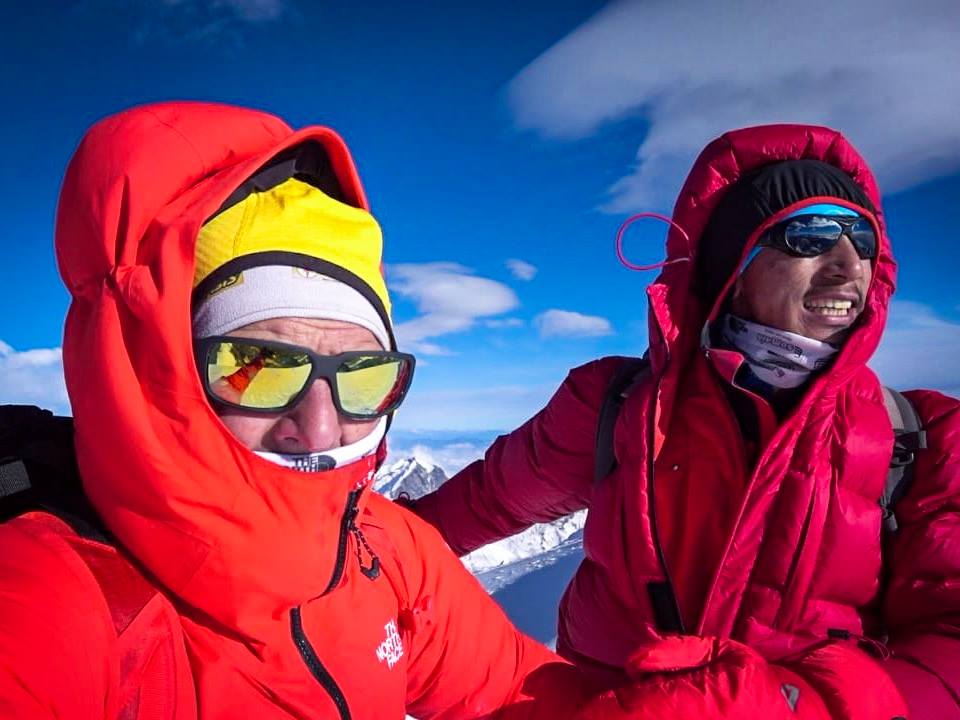 Simone Moro (left) and Pemba Gelje Sherpa facing the wind on Mera Peak summit, before attempting winter Manaslu