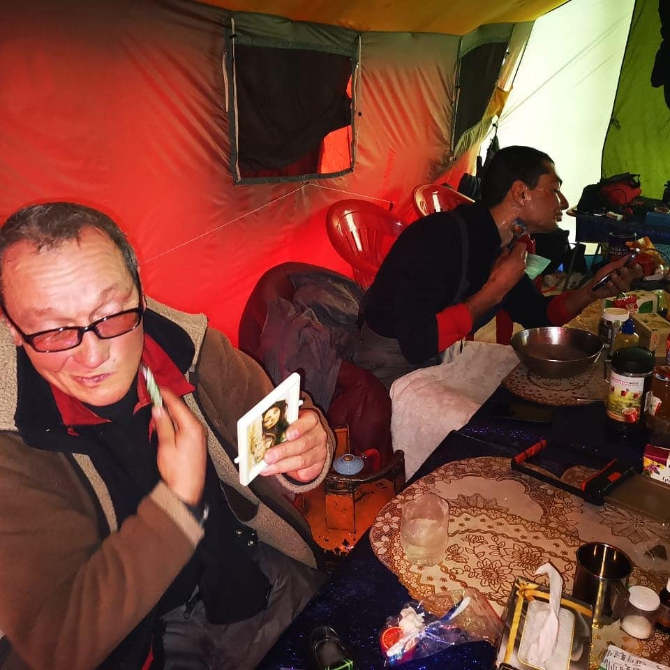 Russian/Kazakh/Kyrgyz team members shaving before heading up on winter K2