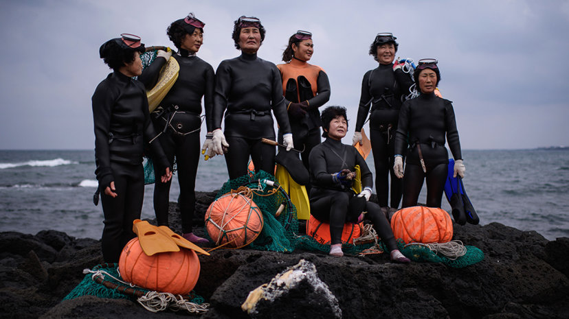 Group of Haenyeo women in wetsuits
