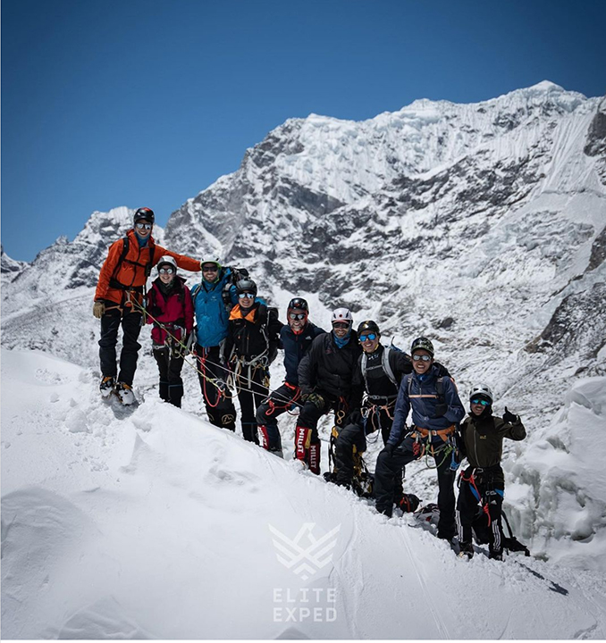 Climbers smiling in the Khumbu Icefall, Mount Everest