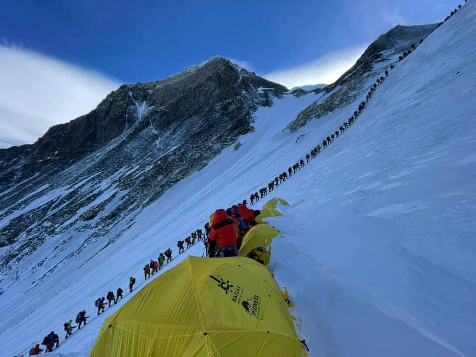 Huge line of climbers in shadow on Everest