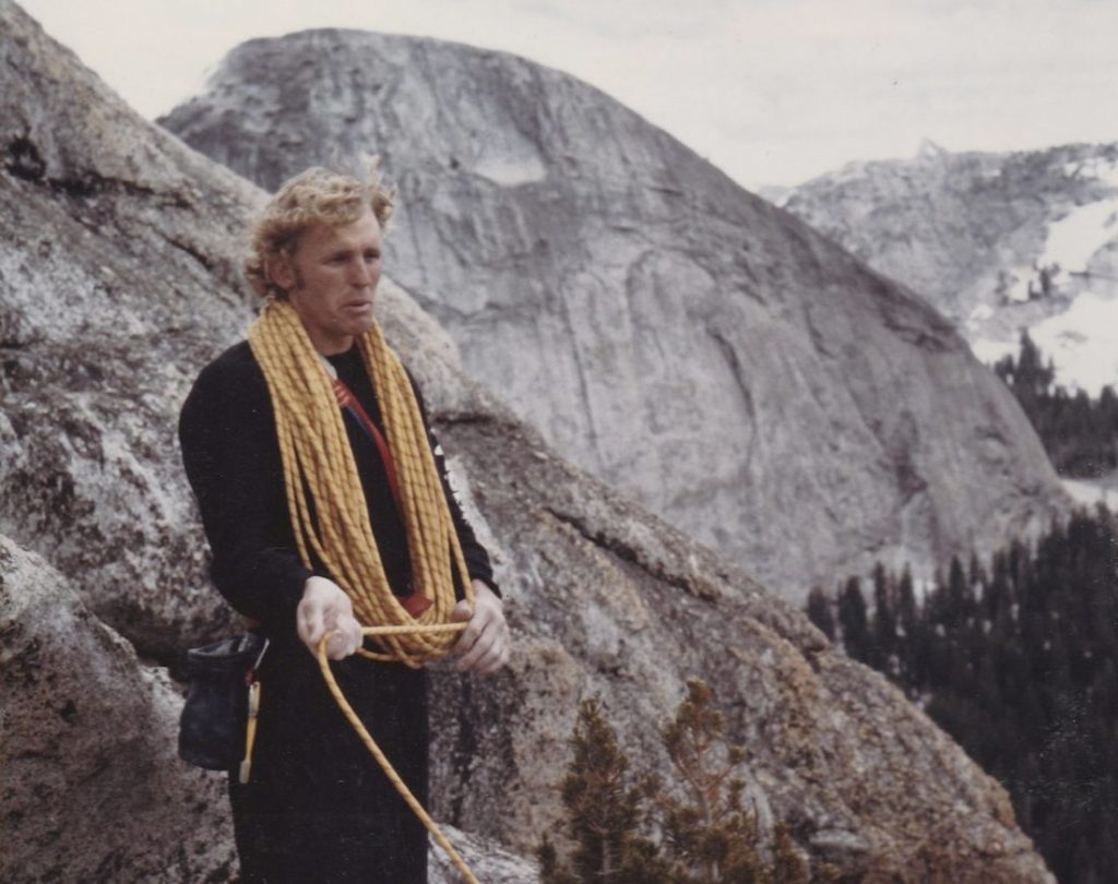 Climber with coiled rope around his neck.