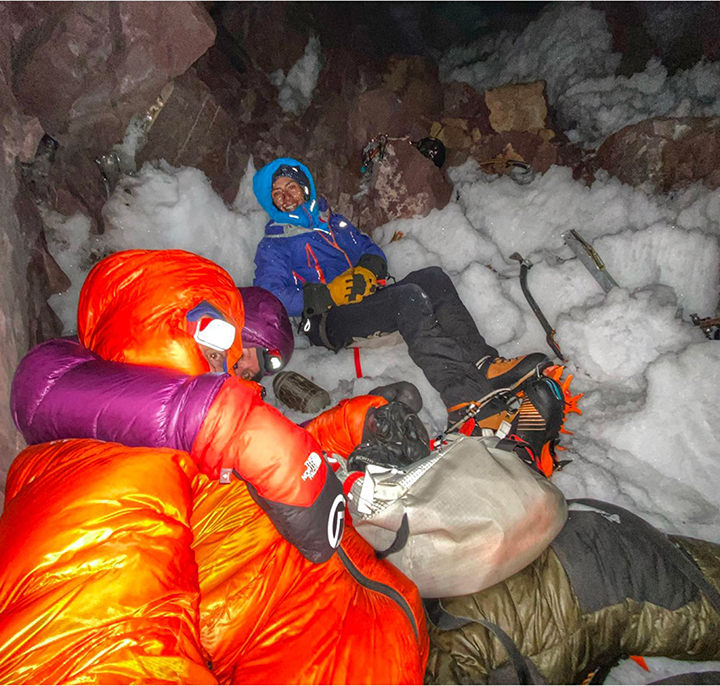 the three climbers rest at their bivy ledge