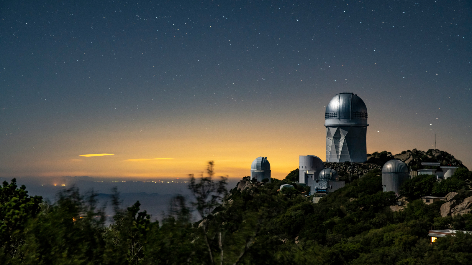A view of the Mayall Telescope (tallest telescope at right), home of DESI, at Kitt Peak National Observatory near Tucson, Arizona. Credit: Marilyn Chung/Berkeley Lab