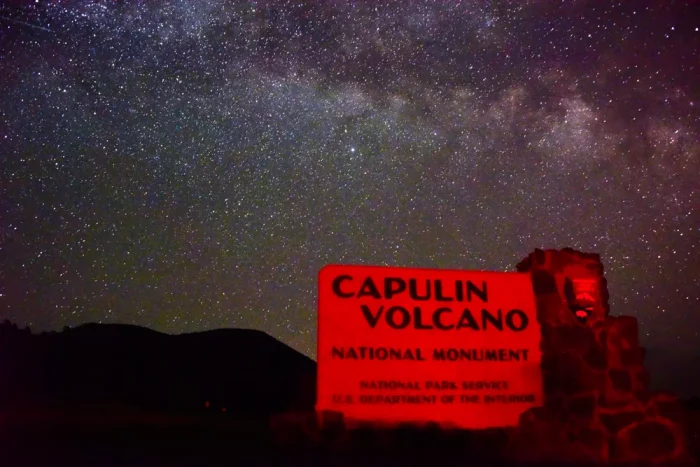 The Summer Milky Way arching across the sky above the Capulin Volcano entrance sign. Capulin Volcano National Monumnet Sign - a dark sky location