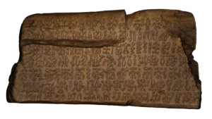 a wooden tablet inscribed with a glyphic language