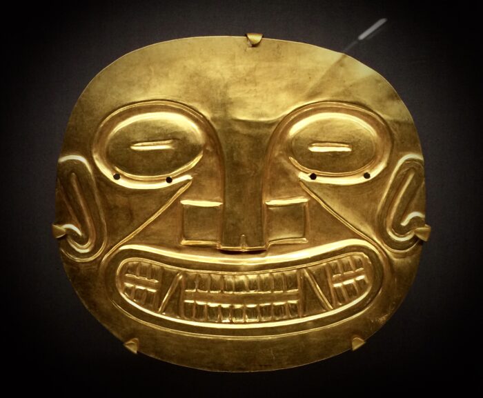 a bright gold plate resembling a face