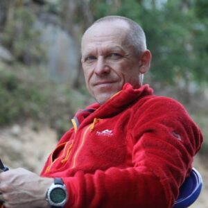 Close shot of Hamor sitting in the open, wearing a polar fleece.