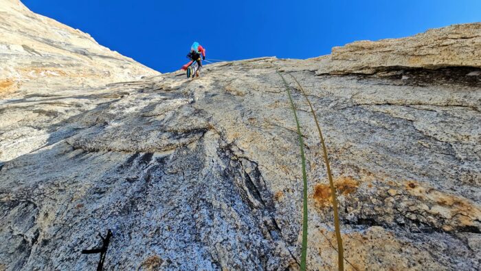 The climber as seen from below up a rock face. 