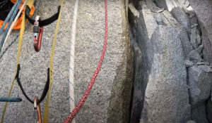 climbing ropes and a crack with some ice inside on a granite wall.