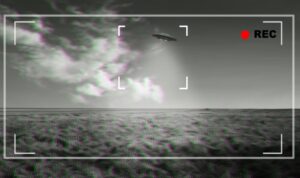 UFO, alien and viewfinder on a camera display to record a flying saucer in the sky over area 51.