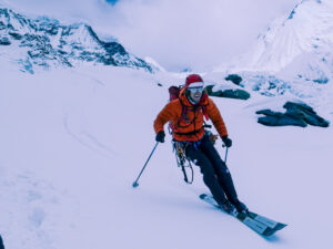 Skier descending on a mountain landscape.