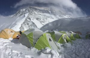 tents semy-buried in fresh snow, the North side of Everest in background.