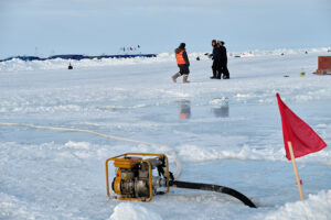 workers standing on sea ice