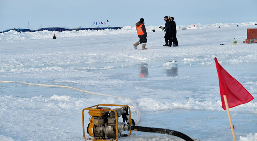 workers standing on sea ice