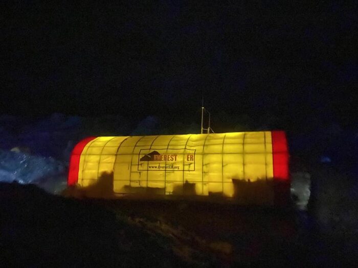 The Everest ER tent lit up at night.