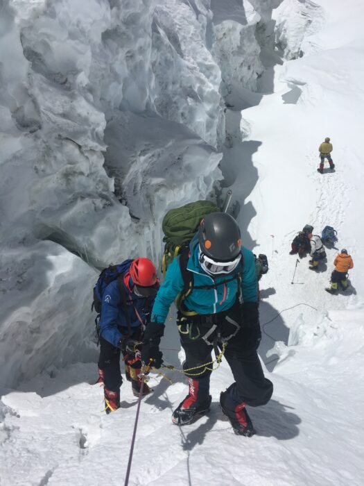 Climbers on steep snow terrain with seracs