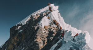 a line of climbers on Everest at the Hillary Step