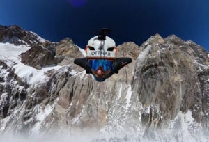 The wingsuit pilot as seen from a frontal headcam, Aconcagua south face behind.