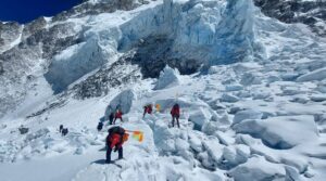 Sherpas on a mace of ice on Everest plant flags to mark the route