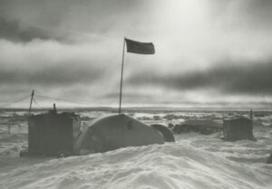 black and white pic of huts on sea ice