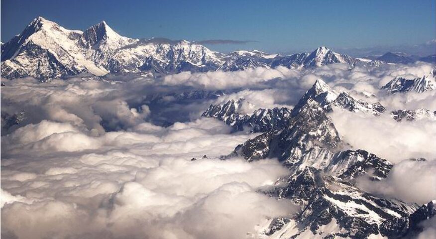 Shisha Pangma looking far away, with low clouds covering the Tibetan valleys.