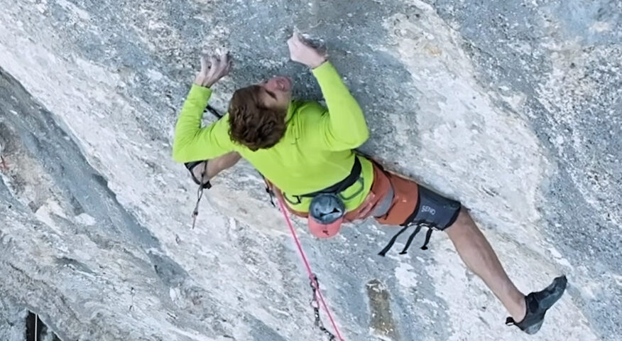 climber on a step, colorful limestone wall