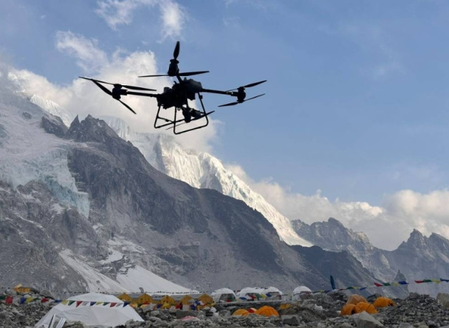 A drone flying over a high altitude mountain Base Camp