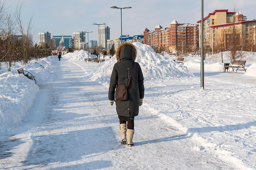 woman walks along snowy Russian street