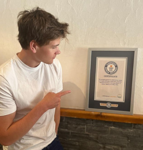 McKenzie points to a Guinness World Record certificate framed