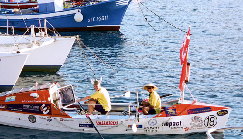 two ocean rowers in rowboat in port