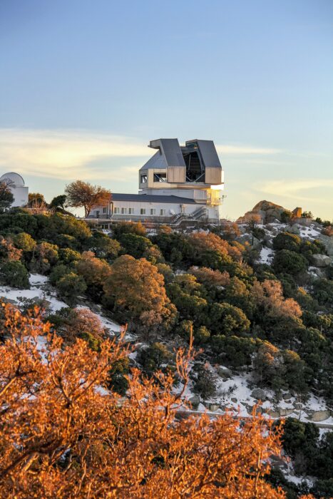 telescope on top of a snowy, vegetated hill
