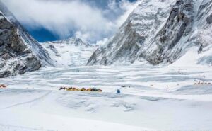 Tents among huge horizontal crevasses at the Valley of Silence, the Lhotse face behind.