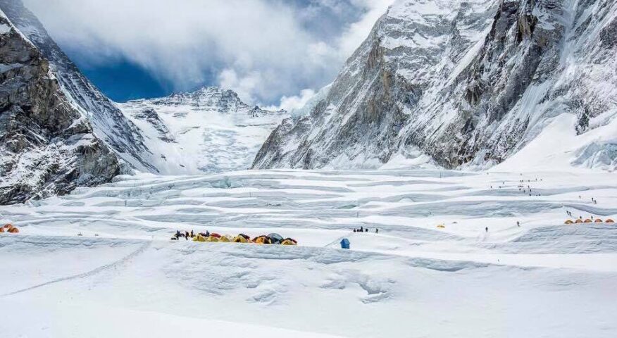Tents among huge horizontal crevasses at the Valley of Silence, the Lhotse face behind.