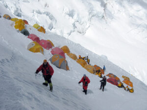 tens on the slope of Lhotse face and three climbers clipped to fixed ropes