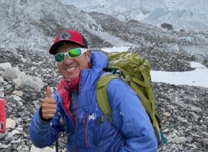 Hugo Ayaviri gives a thumbs-up at Everest Base Camp before heading up the moraine