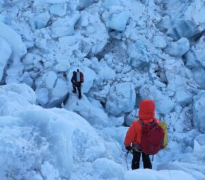Climbers descending among a maze of ice blocks on Everest's Khumbu Icefall.