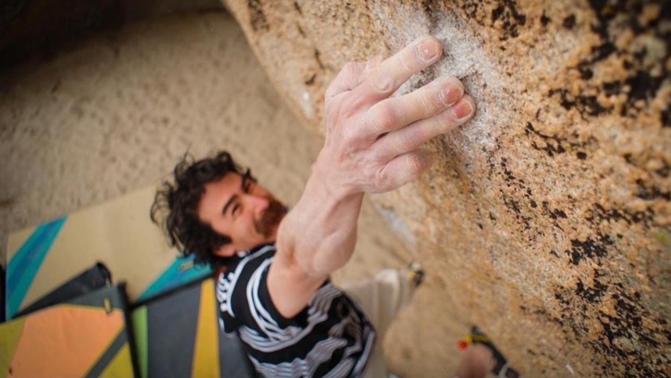 mustached climber crimping hard