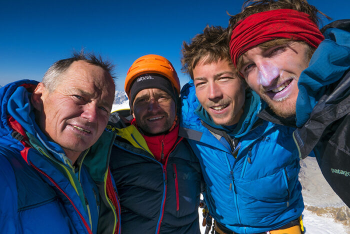 The climbers smile on a summit photo