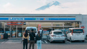 Tourists stand in the middle of the street to look at Mount Fuji,