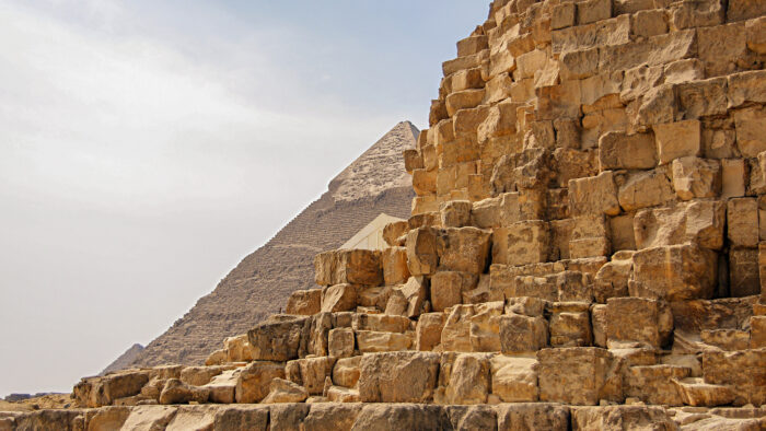 a shot of the pyramids at Giza with stone blocks evident