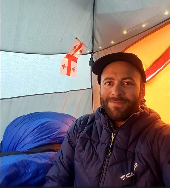 Badriashvili in a tent with a Georgia flag behind