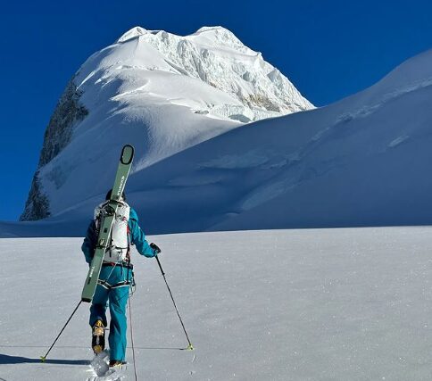 Arnold heads up a snowy ramp with kis on his backpack.