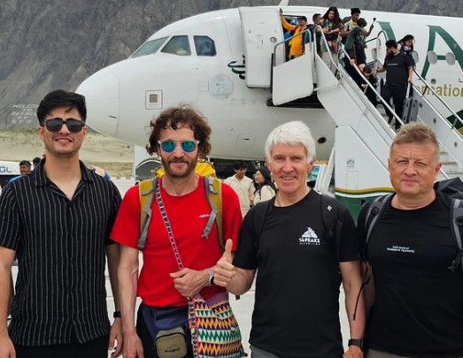 the climbers at Skardu airport, in front of the plane