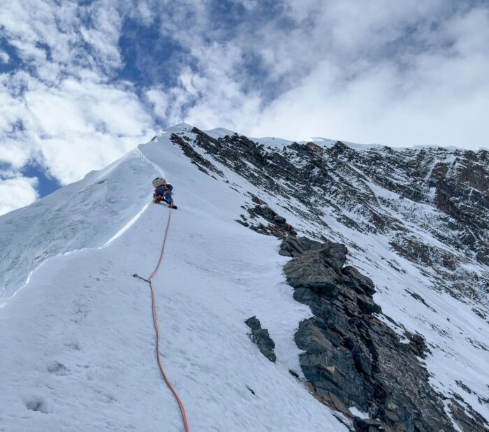 A climber on a snow ridge to the summit of Patrasi