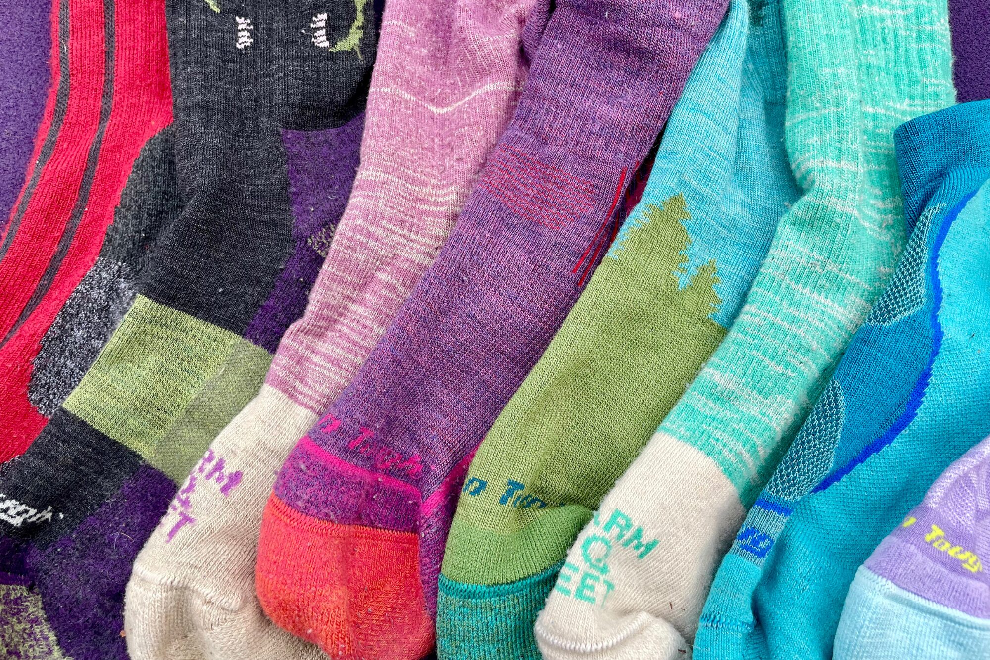 A brigh, colorful pile of different socks that we tested. 