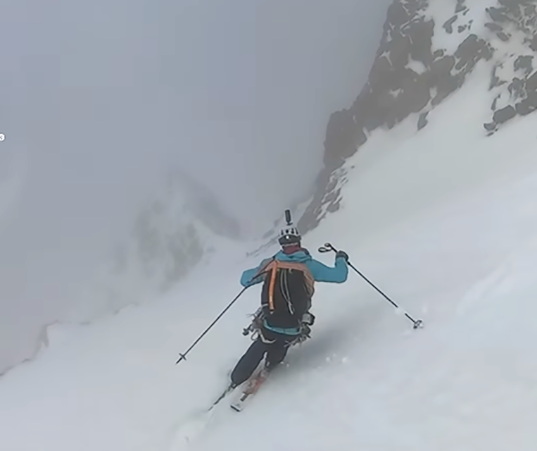 Bruchez skis in the fog on a very steep snow ramp