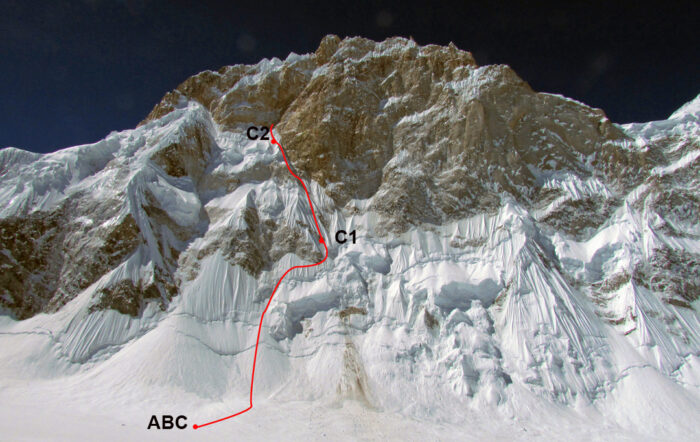 The formidable north face of the Ogre with a route marked in red going up to a rock band.