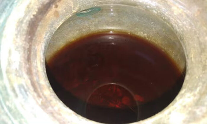 close-up of dark liquid inside container