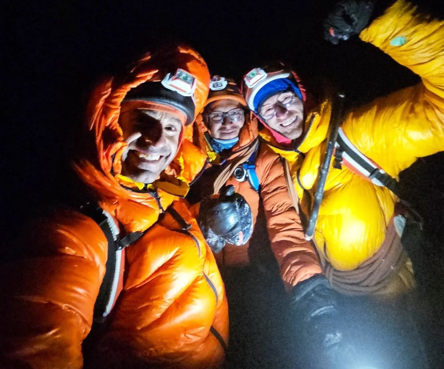 The climbers smile in full night
